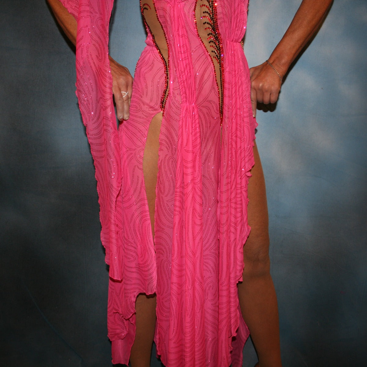 Crystal's Creations close up bottom view of Pink Latin/rhythm dress created of sheer swirls glitterknit on nude illusion base has the look of a Greek Goddess & is embellished with Swarovski stonework in Indian pink & bronze.