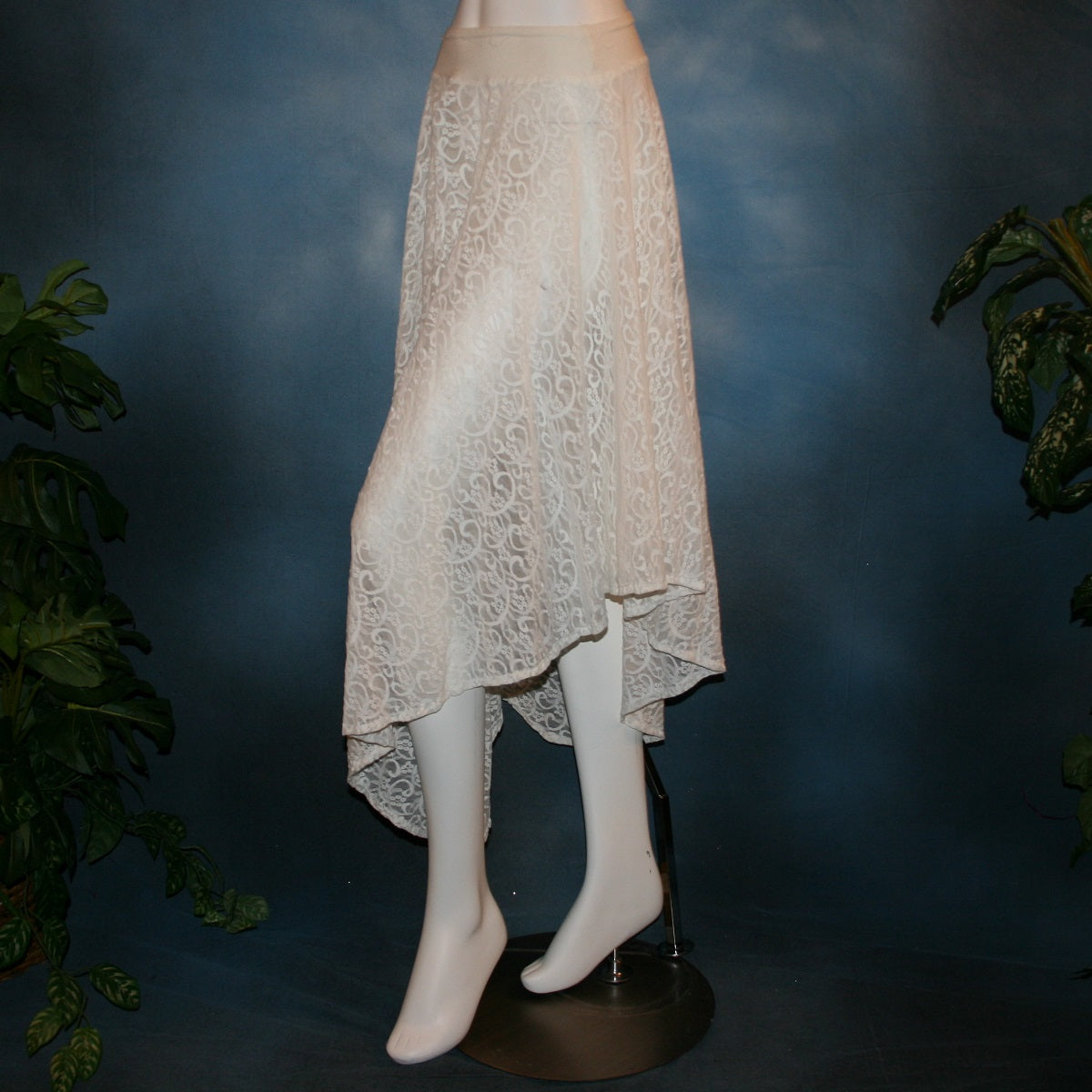 side view of white ballroom skirt crafted from stunning stretch lace features an extra full, waltzing length design and is slightly shorter on the sides.