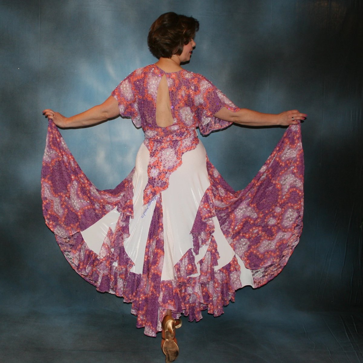 Crystal's Creations back view of White ballroom dress with a romantic country dance flair created on a luxurious white stretch velvet base, deep orchid and peach flowered stretch lace insets, flounces and bodice overlays embellished with Swarovski rhinestone work, hand beading