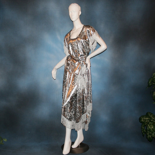 Crystal's Creations Silver two panel Latin/rhythm skirt & top that has hand beading on neck edge of textured silver beads, with metallic fringe, was created of a leopard print knit with silver metallic on one side.