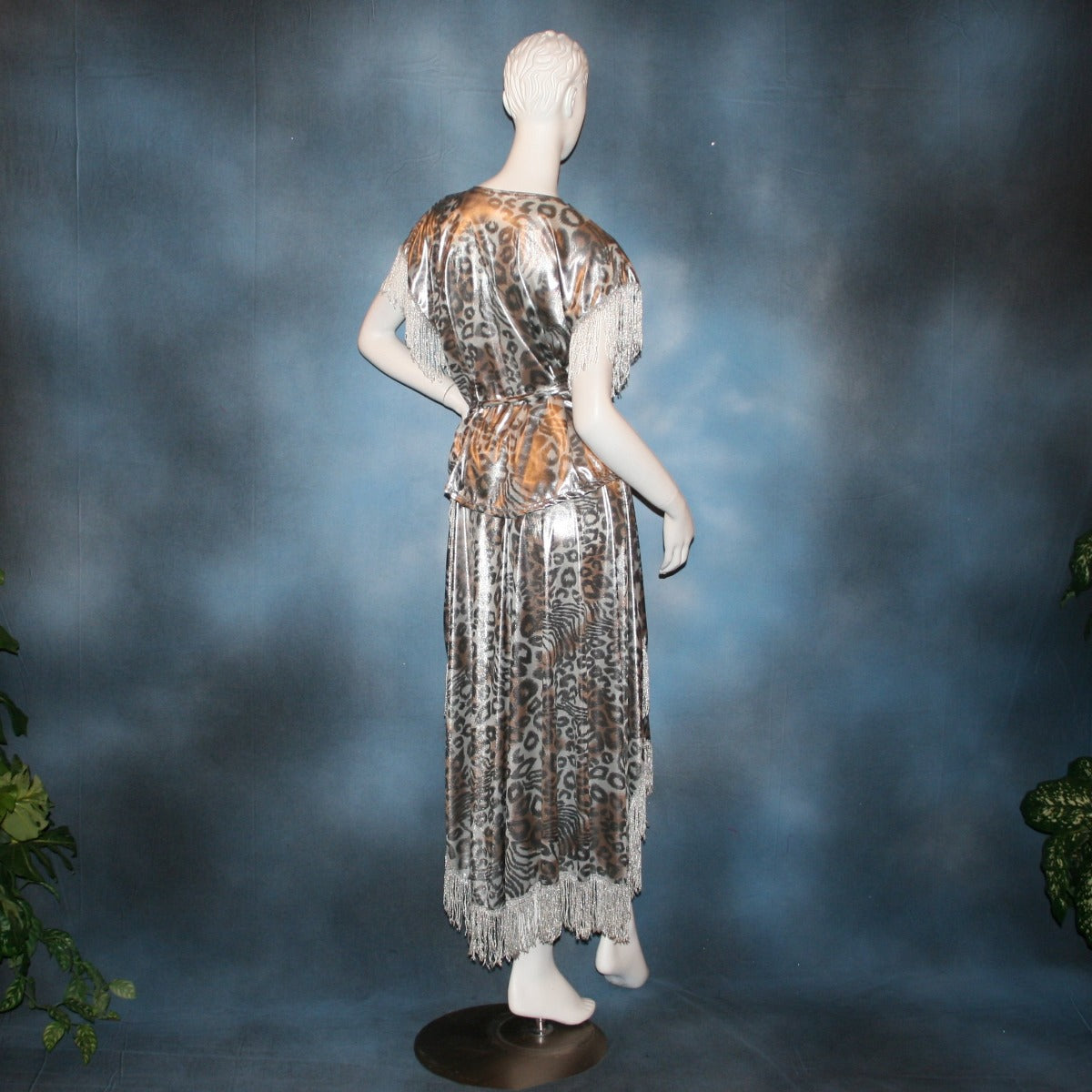 Crystal's Creations back view of Silver two panel Latin/rhythm skirt & top that has hand beading on neck edge of textured silver beads, with metallic fringe, was created of a leopard print knit with silver metallic on one side.