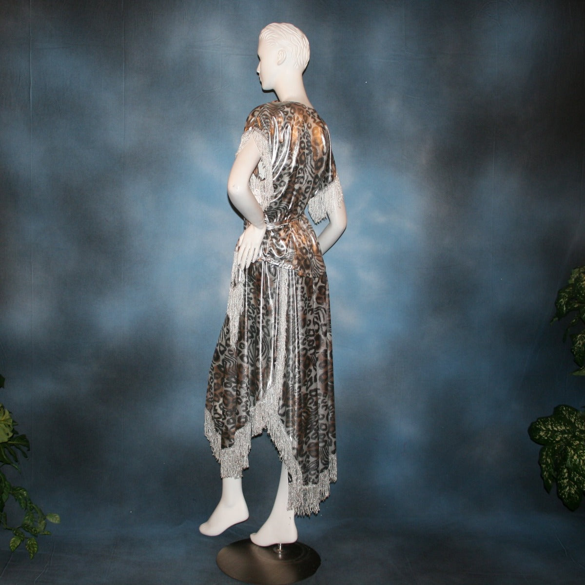 Crystal's Creations side view of Silver two panel Latin/rhythm skirt & top that has hand beading on neck edge of textured silver beads, with metallic fringe, was created of a leopard print knit with silver metallic on one side.