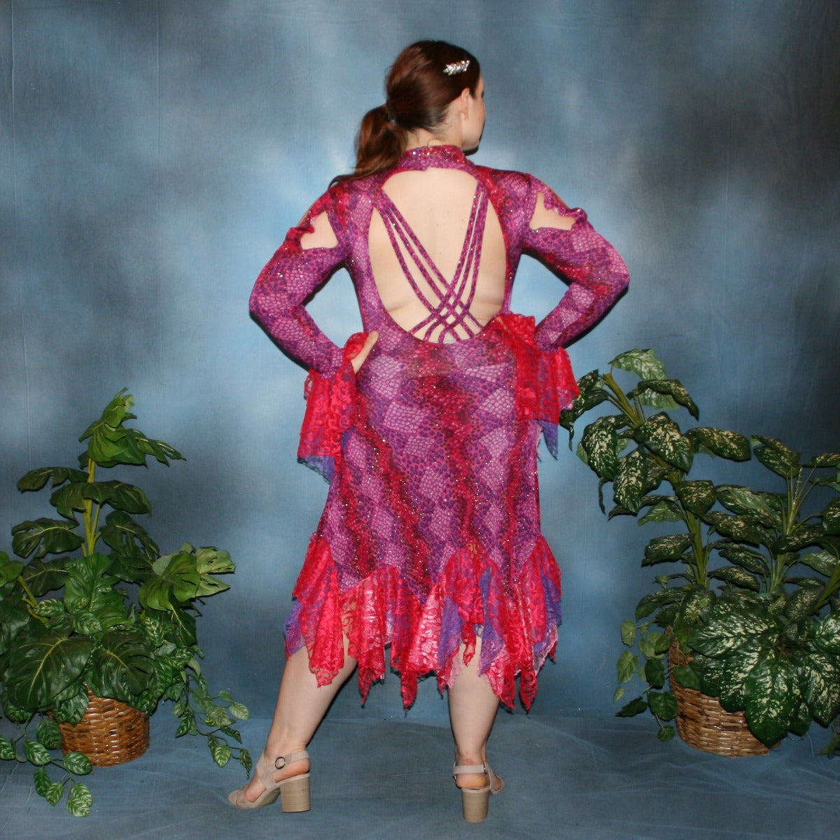 Crystal's Creations back view of Red & purple Latin/rhythm dress created in gorgeous printed slinky glitterknit in reptilia print of reds, purples & orchids with nude illusion cutouts…oodles of lace flounces…embellished with siam & siam Ab Swarovski stonework.
