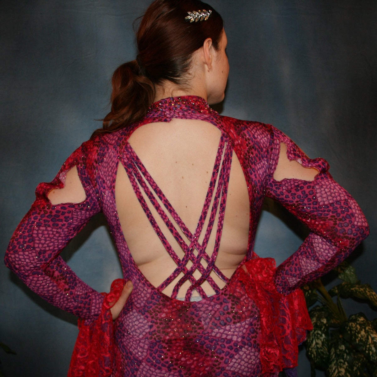 Crystal's Creations back close up view of Red & purple Latin/rhythm dress created in gorgeous printed slinky glitterknit in reptilia print of reds, purples & orchids with nude illusion cutouts…oodles of lace flounces…embellished with siam & siam Ab Swarovski stonework.