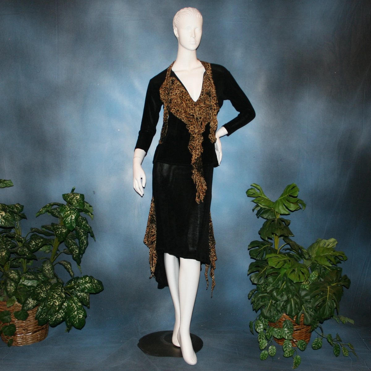 Black ballroom dance top with cheetah ruffly neck & tie of luxurious black slinky and black Latin/rhythm flaired skirt with cheetah print slinky ruffly accents, which drapes down longer in the back. Great set for ballroom teachers!Tie on top can be worn open or closed. 