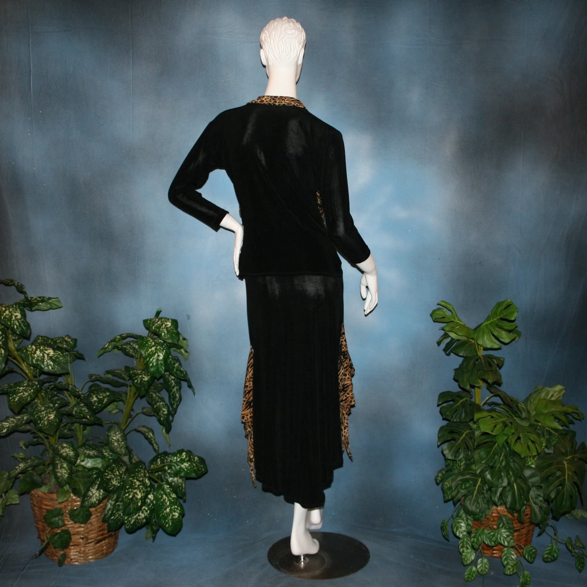 back view of Black ballroom dance top with cheetah ruffly neck & tie of luxurious black slinky and black Latin/rhythm flaired skirt with cheetah print slinky ruffly accents, which drapes down longer in the back. Great set for ballroom teachers!Tie on top can be worn open or closed.