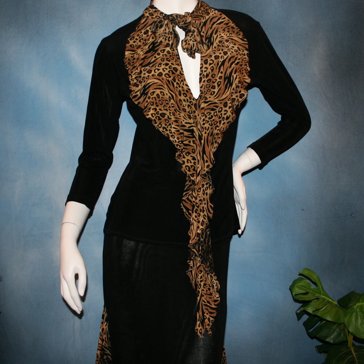 close upper  view of Black ballroom dance top with cheetah ruffly neck & tie of luxurious black slinky and black Latin/rhythm flaired skirt with cheetah print slinky ruffly accents, which drapes down longer in the back. Great set for ballroom teachers!Tie on top can be worn open or closed.