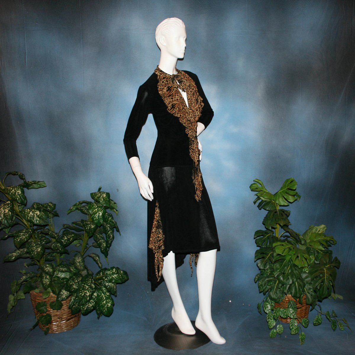 right side view of Black ballroom dance top with cheetah ruffly neck & tie of luxurious black slinky and black Latin/rhythm flaired skirt with cheetah print slinky ruffly accents, which drapes down longer in the back. Great set for ballroom teachers!Tie on top can be worn open or closed.