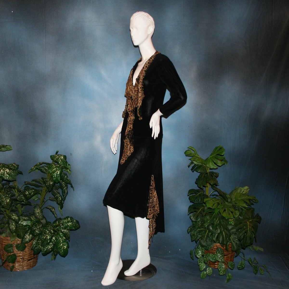 side view of Black ballroom dance top with cheetah ruffly neck & tie of luxurious black slinky and black Latin/rhythm flaired skirt with cheetah print slinky ruffly accents, which drapes down longer in the back. Great set for ballroom teachers!Tie on top can be worn open or closed.