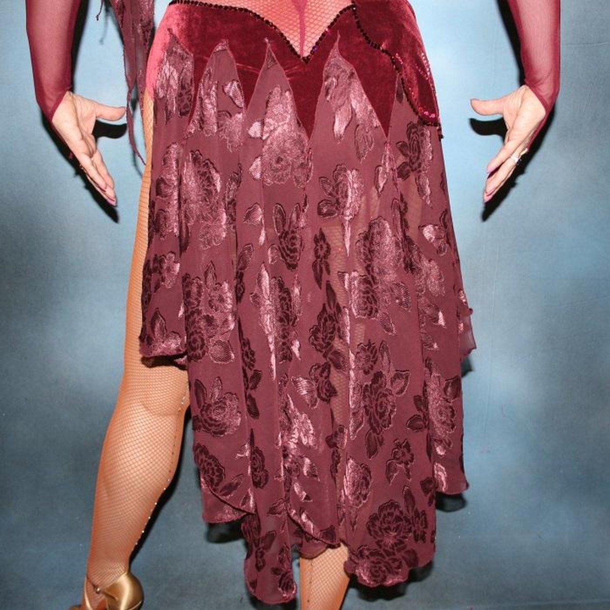 Crystal's Creations close up bottom view of Burgundy stretch velvet Latin/rhythm dress created on burgundy stretch mesh base with rose patterned clip/cut chiffon, is embellished with burgundy, fuchsia, antique rose, & orchid Swarovski rhinestone work & a touch of Swarovski hand beading.