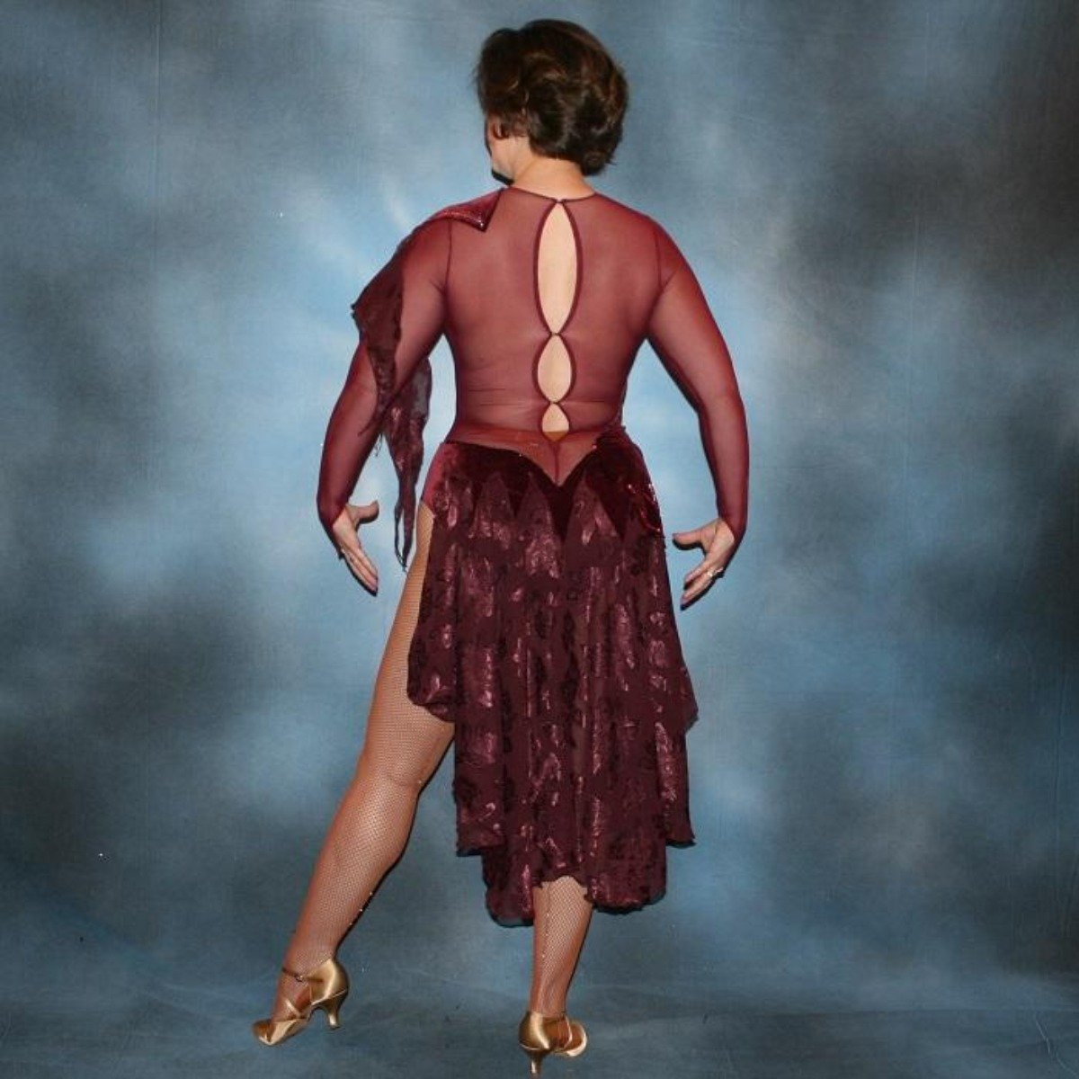 Crystal's Creations back view of Burgundy stretch velvet Latin/rhythm dress created on burgundy stretch mesh base with rose patterned clip/cut chiffon, is embellished with burgundy, fuchsia, antique rose, & orchid Swarovski rhinestone work & a touch of Swarovski hand beading.