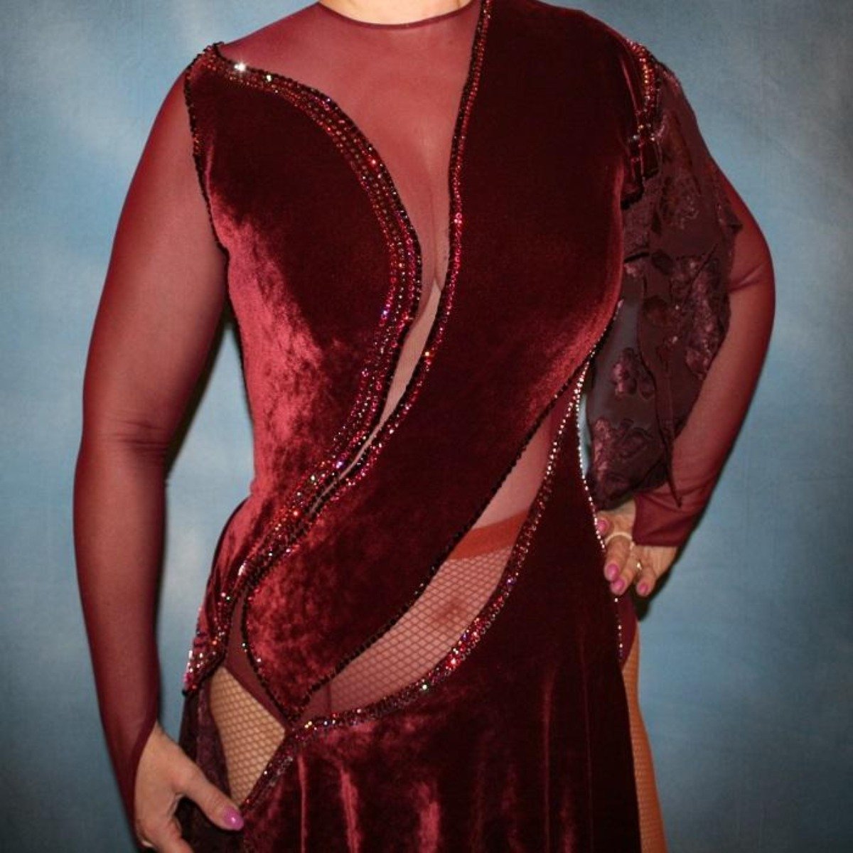 Crystal's Creations close up view of Burgundy stretch velvet Latin/rhythm dress created on burgundy stretch mesh base with rose patterned clip/cut chiffon, is embellished with burgundy, fuchsia, antique rose, & orchid Swarovski rhinestone work & a touch of Swarovski hand beading.