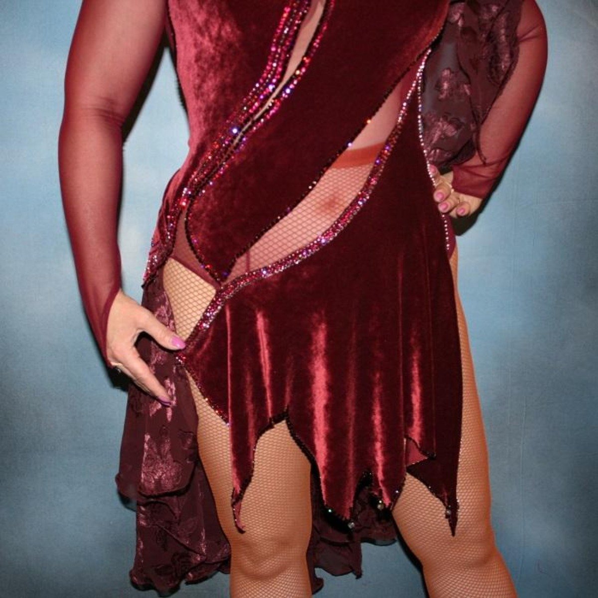 Crystal's Creations close up of Burgundy stretch velvet Latin/rhythm dress created on burgundy stretch mesh base with rose patterned clip/cut chiffon, is embellished with burgundy, fuchsia, antique rose, & orchid Swarovski rhinestone work & a touch of Swarovski hand beading.