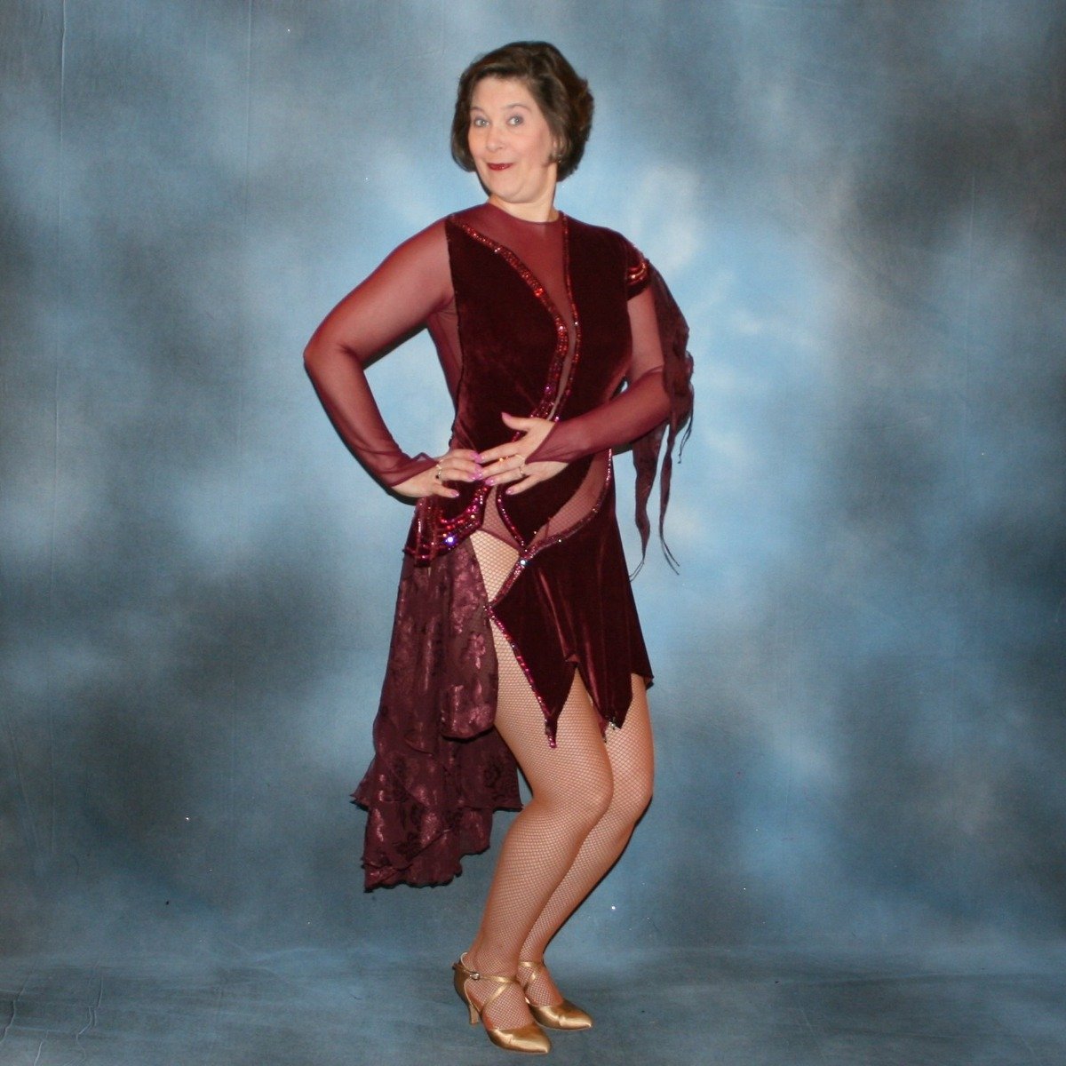 Crystal's Creations Burgundy stretch velvet Latin/rhythm dress created on burgundy stretch mesh base with rose patterned clip/cut chiffon, is embellished with burgundy, fuchsia, antique rose, & orchid Swarovski rhinestone work & a touch of Swarovski hand beading.