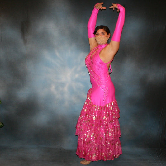 Crystal's Creations Fuchsia tango dress created of textured fuchsia lycra with ruffles of gold leafed patterned chiffon, nude illusion cutouts & low back, is embellished with gold aurum Swarovski rhinestone work & hand beading.