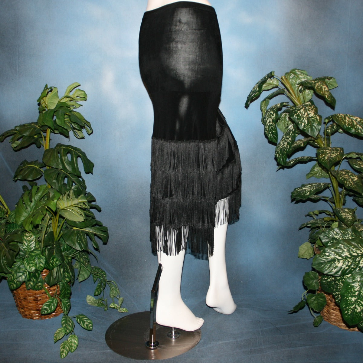back view of Black fringy hip wrap Latin/rhythm skirt, was created of luxurious black solid slinky, with 4 rows of black chainette fringe.