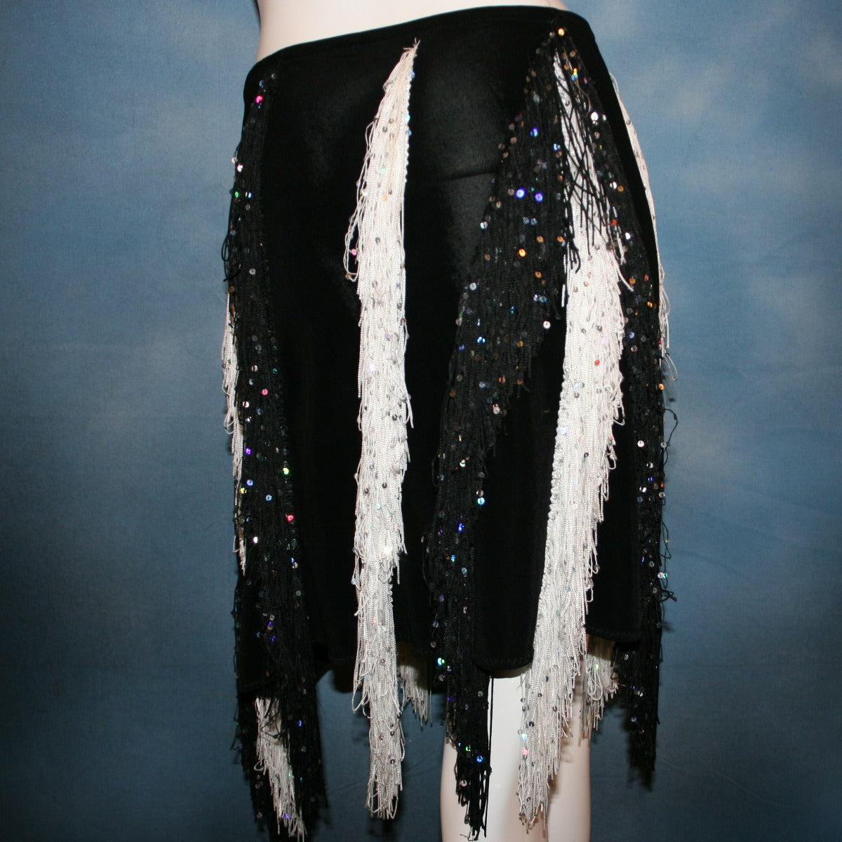 close view of Black & white Latin/rhythm skirt created of luxurious black solid slinky with vertical rows of black & white hologram sequined fringe, would pair greatly with a simple black bodysuit....or a custom created bodysuit or two would be fabulous for versatility, one on the simple classic side & one fabulously ornate with Swarovski rhinestone work!   