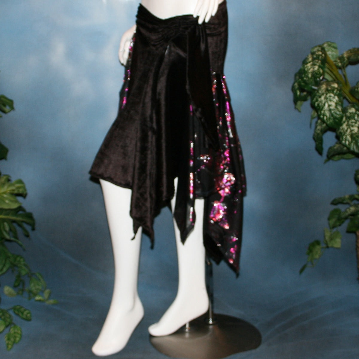 side view of Black Latin/rhythm skirt, wrap style,with scarf cut panels was created with yards of a black & fuchsia metallic cut & clip chiffon on a panne' velvet base with ruching & sash.